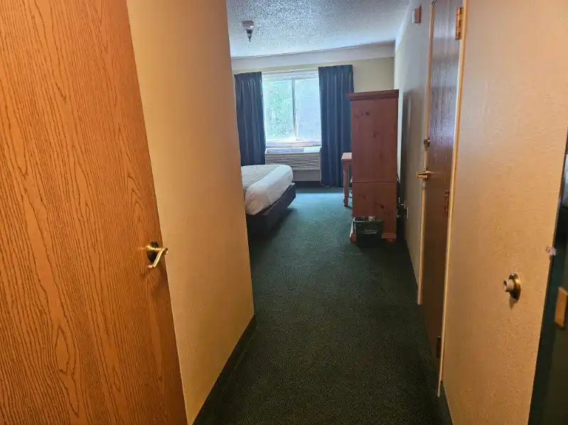 The entry hallway of a guest room looking through to the window